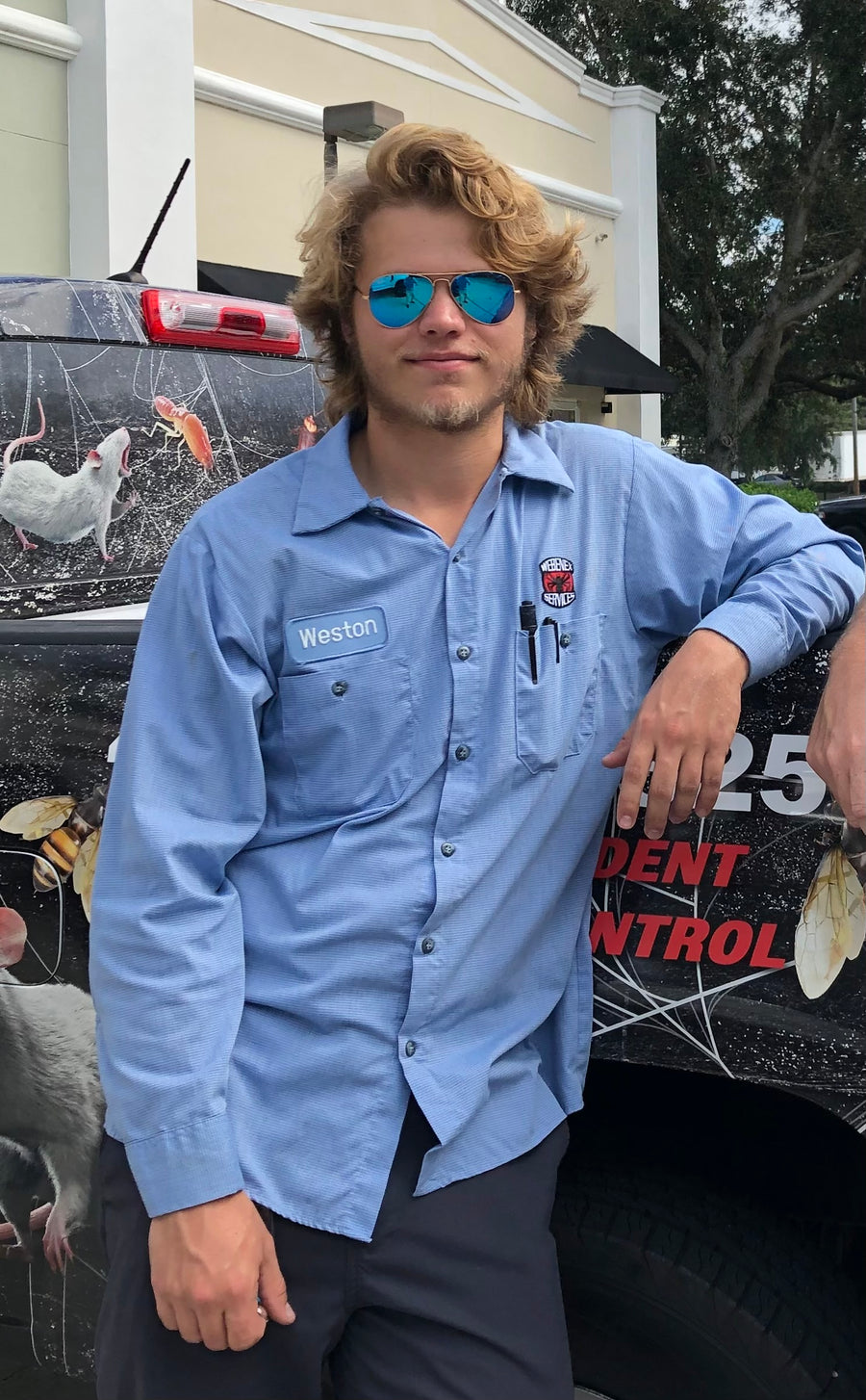 Weston Levingston leaning against a Webenex service truck
