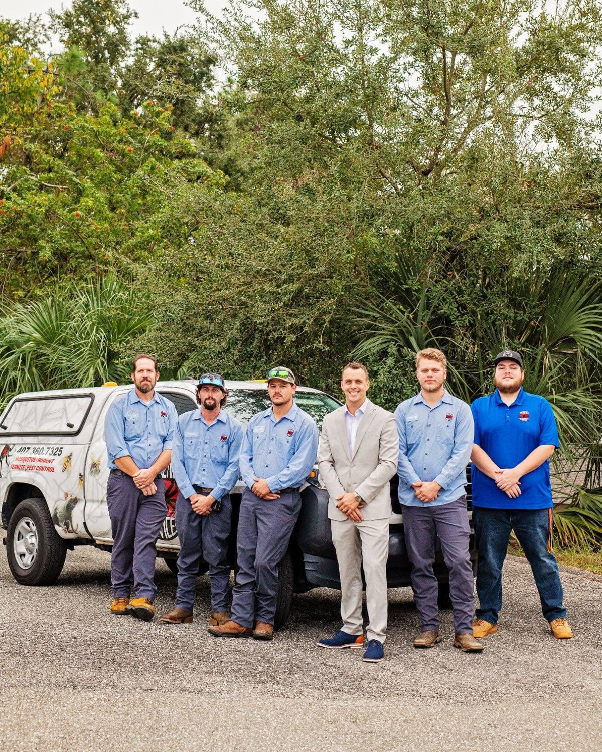 The Webenex Services team of six in uniform in front of a company truck in Clermont, FL